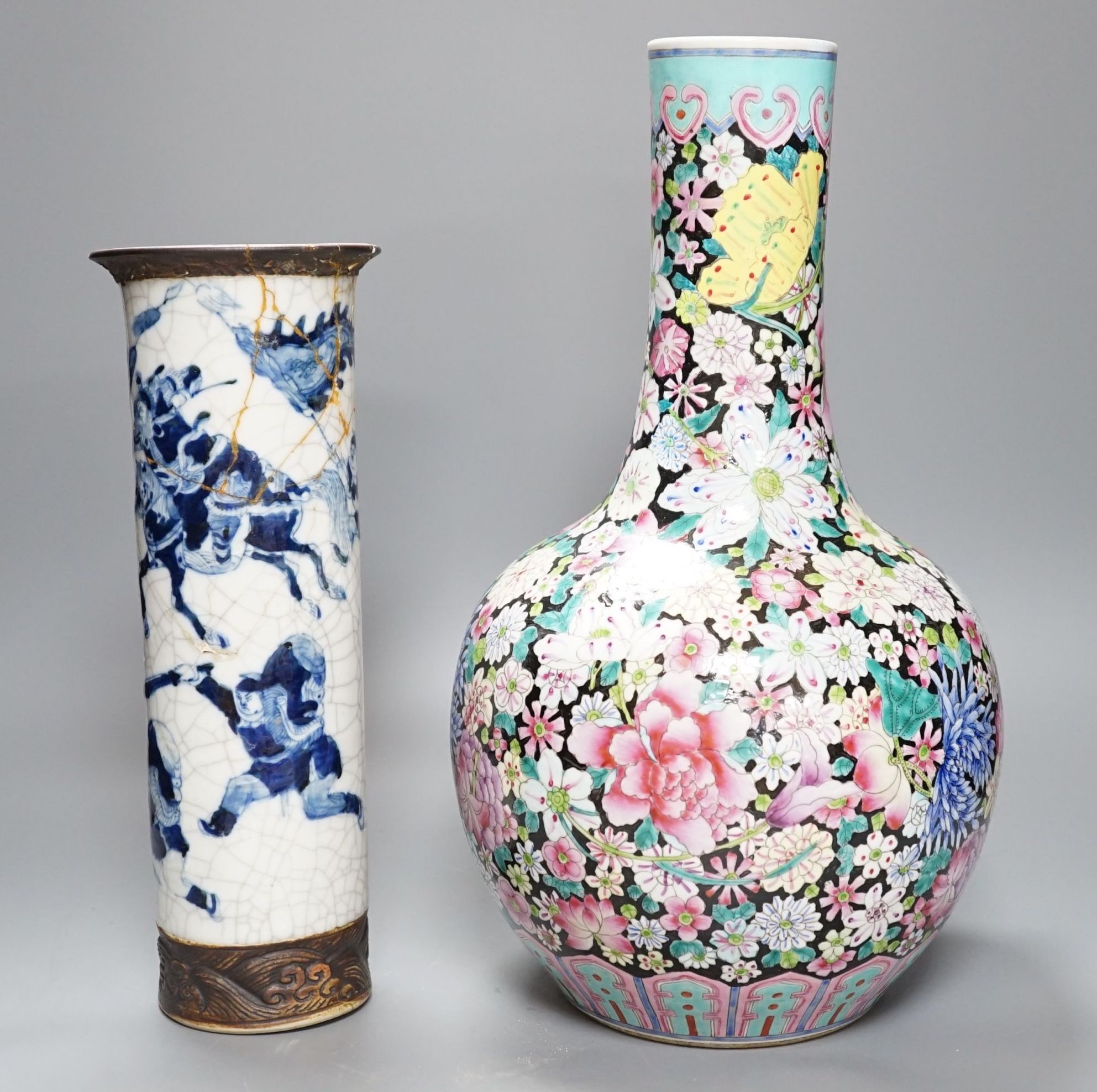 An early 20th century Chinese famille rose thousand flowers bottle vase (restored) together with a Chinese blue and white crackle glazed sleeve vase (a.f)., tallest 40cm